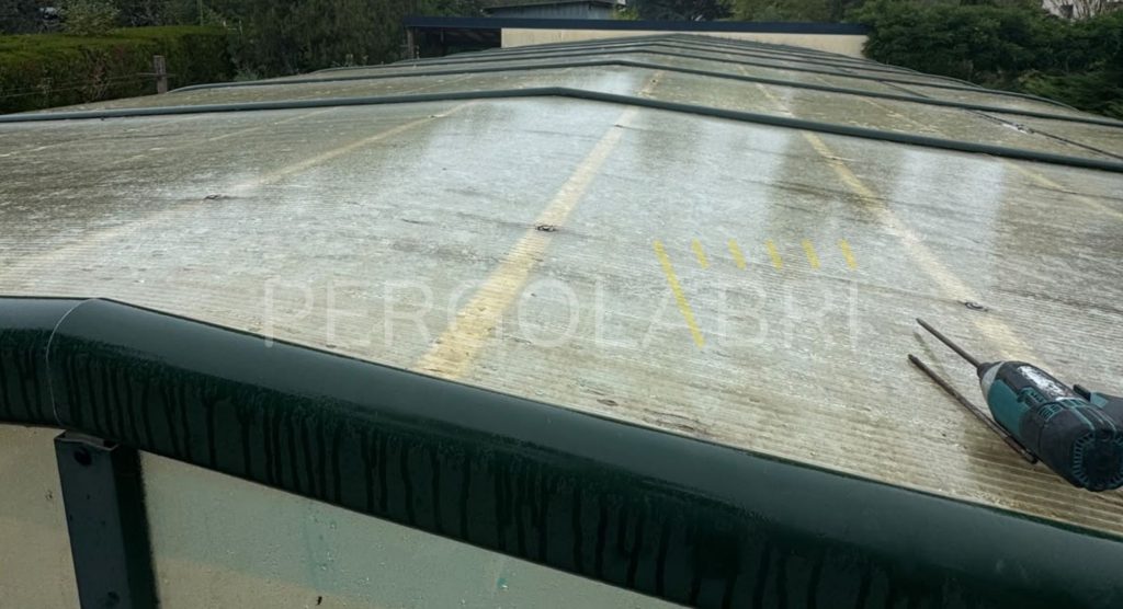 Plaques de polycarbonate jaunies et fragilisées sur la toiture d’un abri de piscine